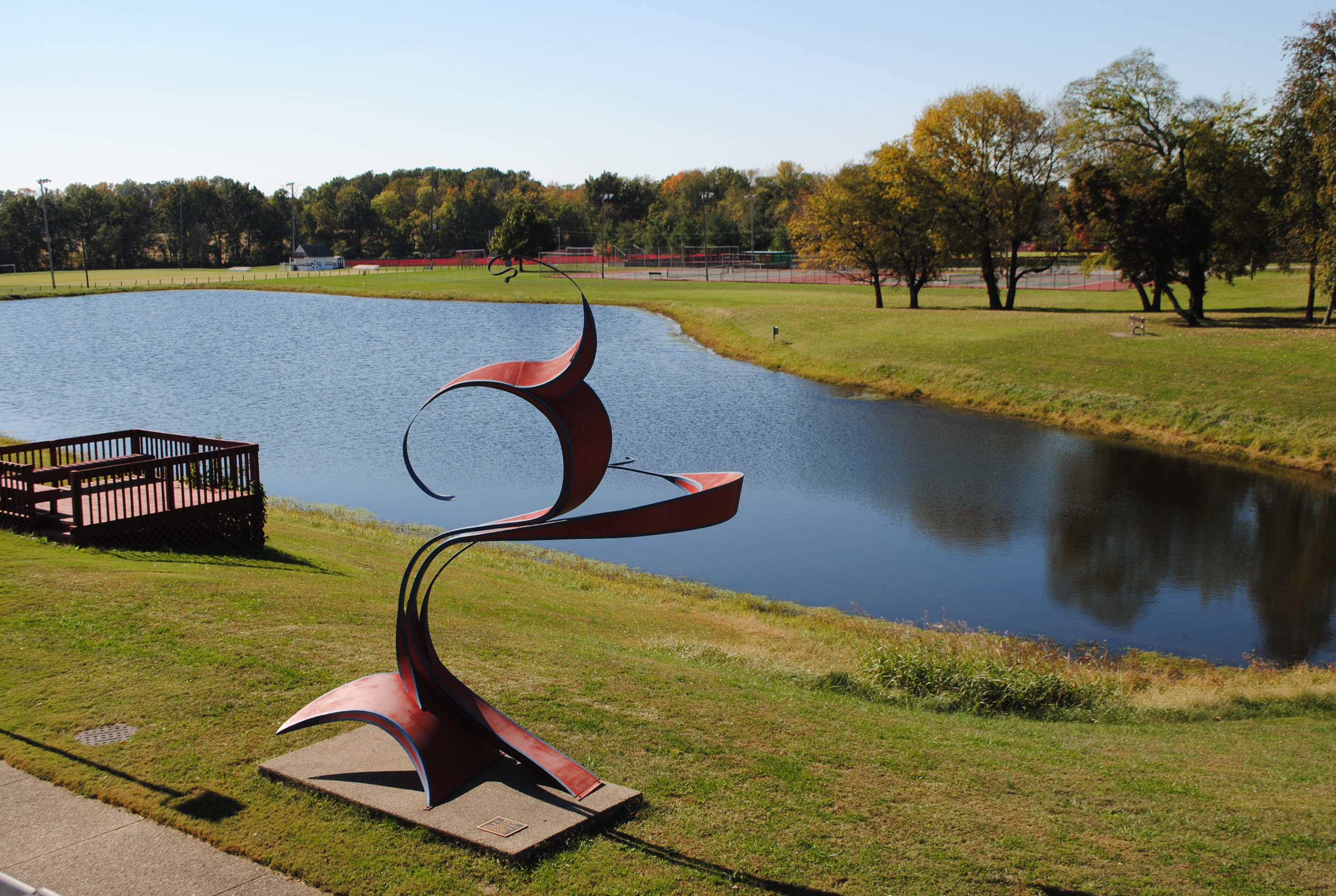 Photo of WVC Campus Grounds featuring Balance artwork and campus lake