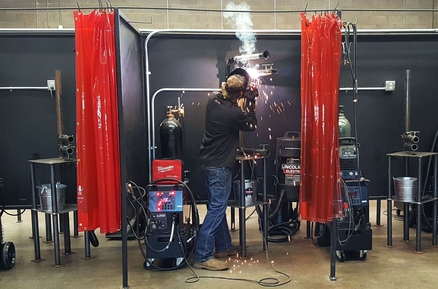 Photo of student welding in the associate degree lab