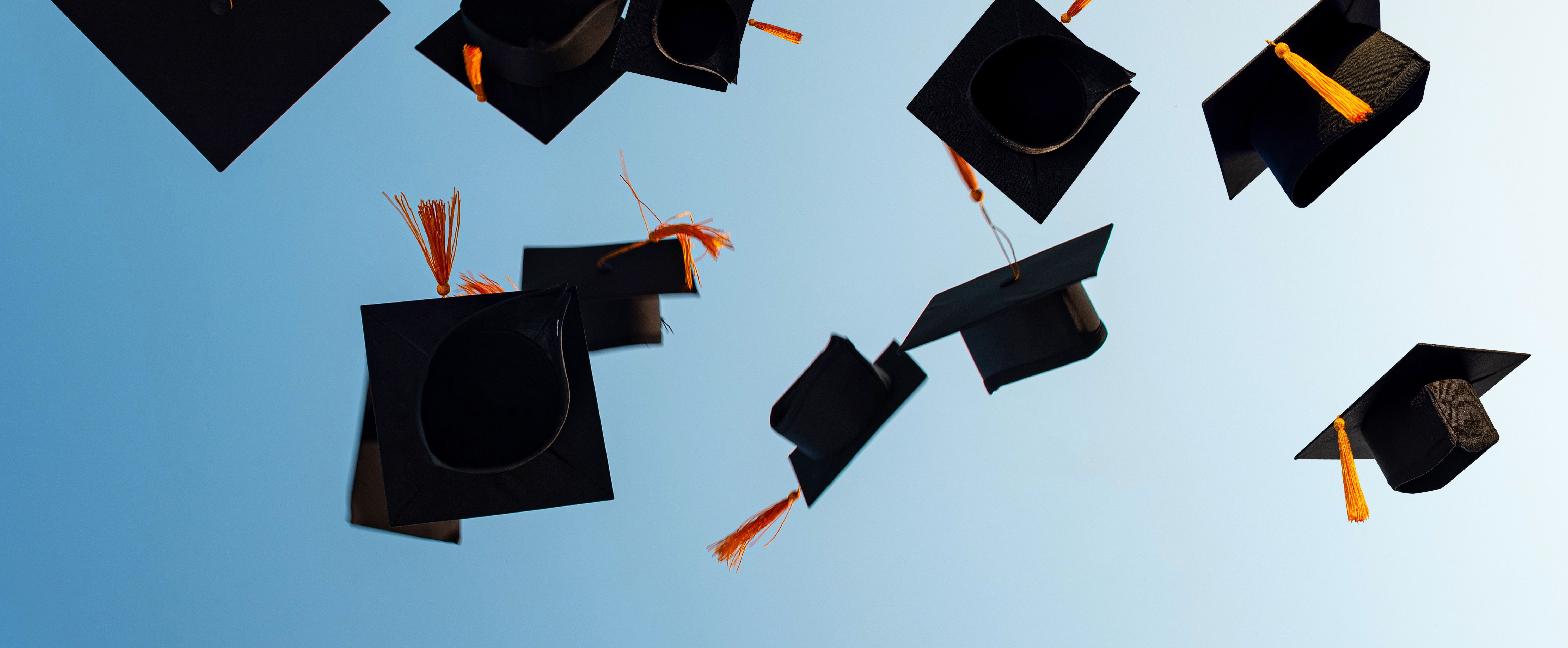 Graduation Caps Flying