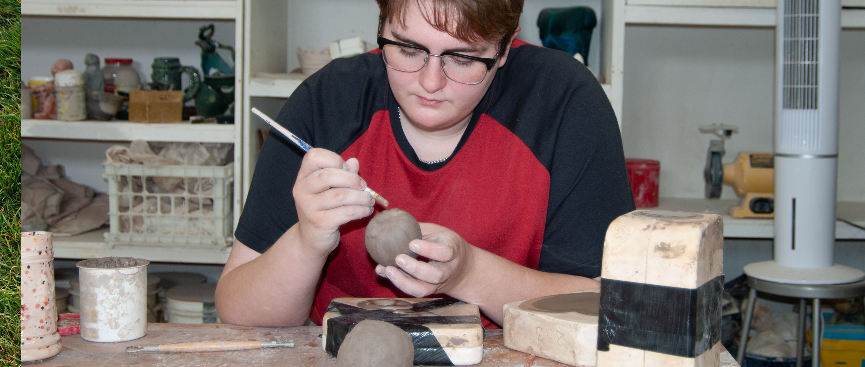 Student working with Clay