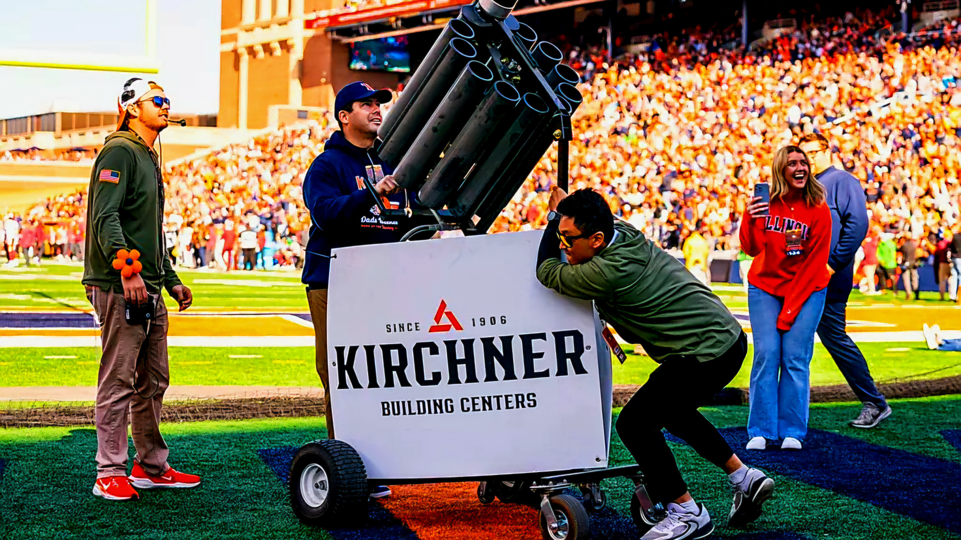 A photo of Cy Yun working at a University of Illinois football game. He's with a crew using a T-shirt cannon.