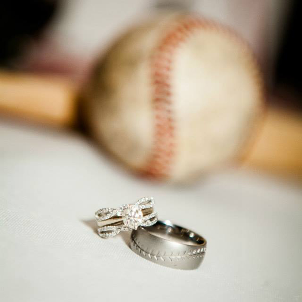 Bride and groom at home plate, exchanging vows.