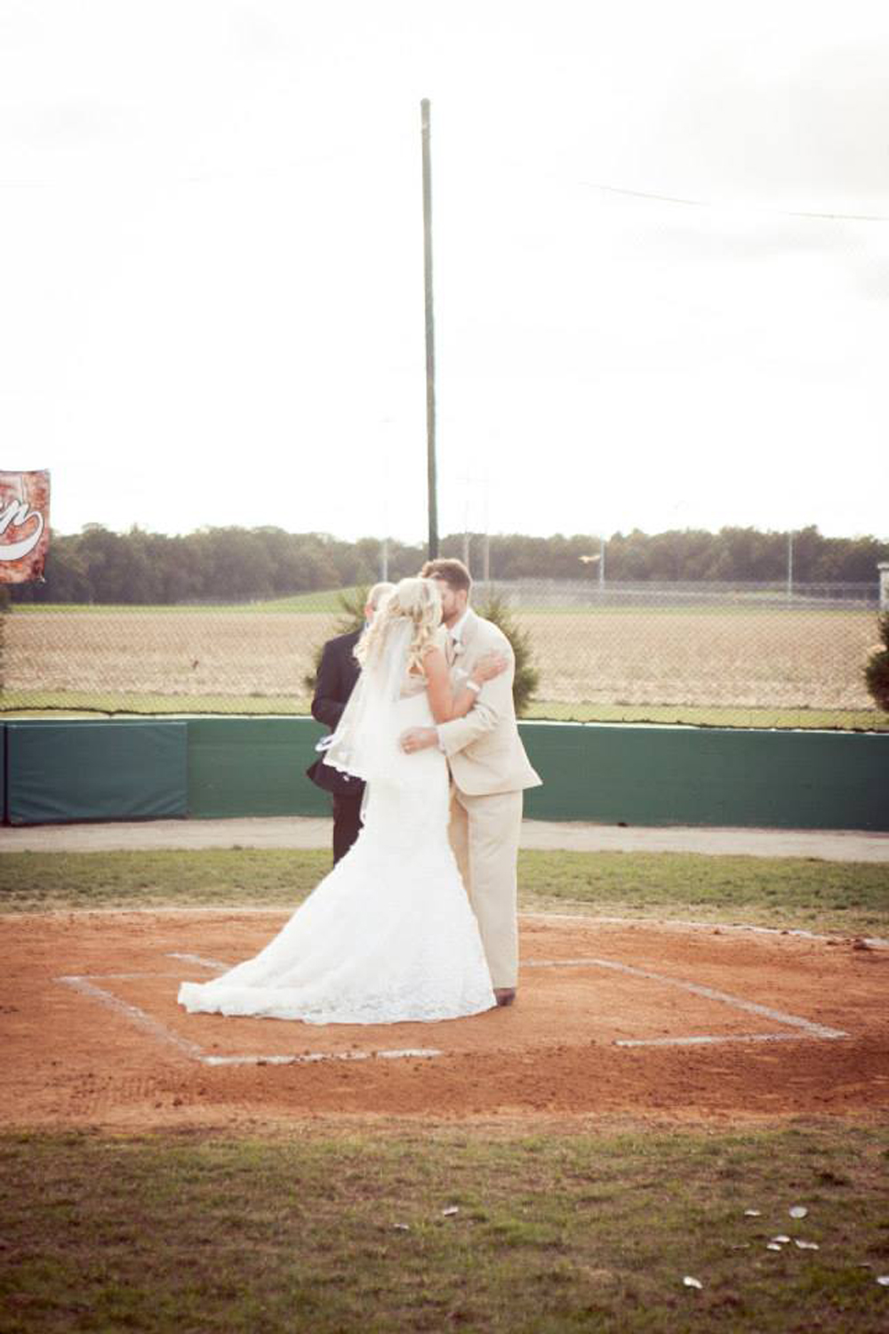 Ross and Nikki Westdorp on the baseball field, celebrating their wedding.