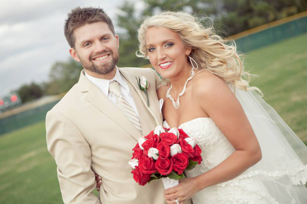 Ross and Nikki Westdorp on their wedding day, smiling and embracing.