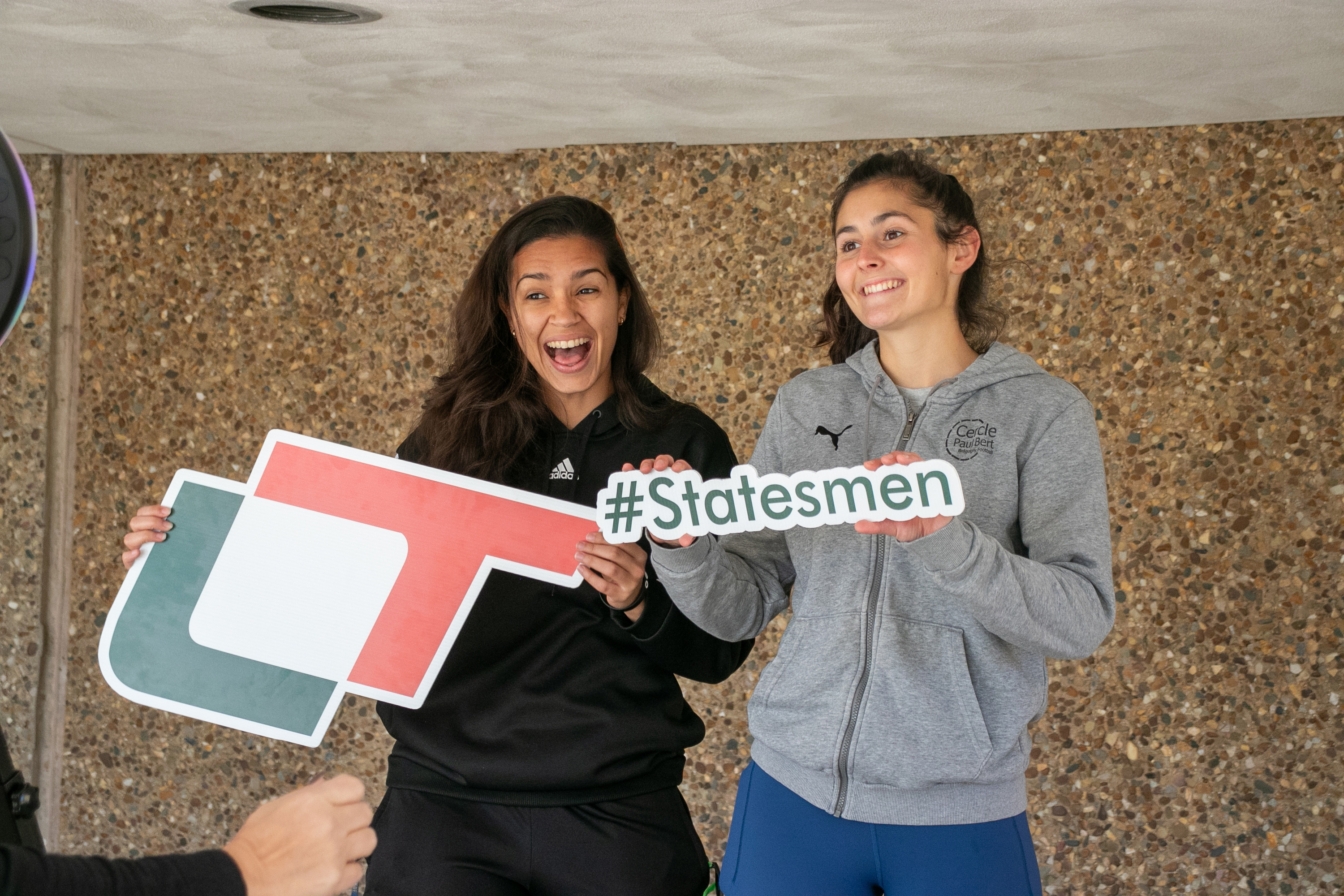 Two excited students pose with Lincoln Trail College signs, including one that reads Statesmen. Their smiles and energy reflect school spirit and pride. The casual setting captures a fun and engaging moment, showcasing the vibrant student experience at LTC.