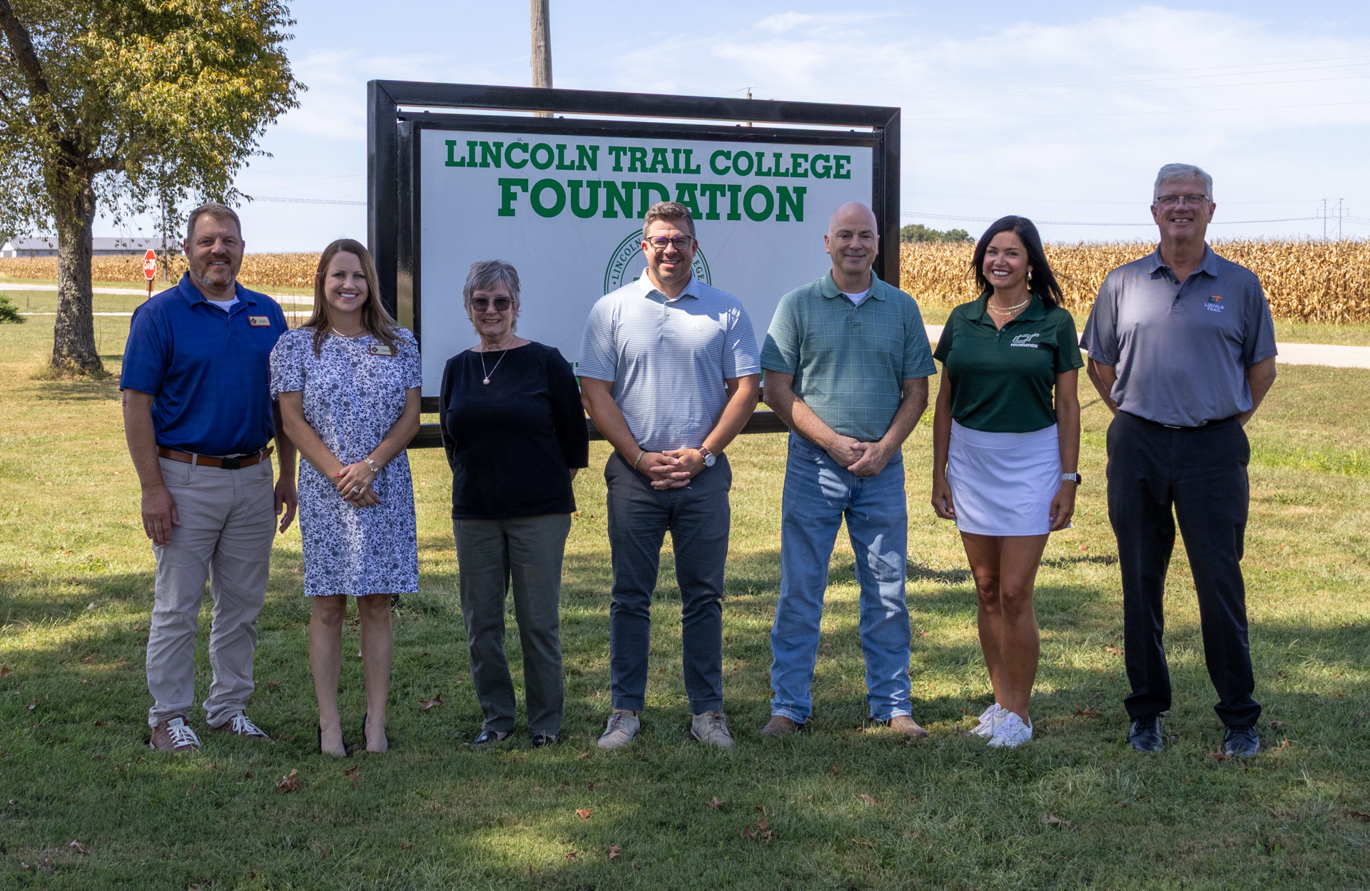 Seven representatives and family members stand outdoors in front of a Lincoln Trail College Foundation sign. From left are First Robinson Savings Bank President Mark Hill, CRA Officer Harlei Payne, Bill Thomas’ wife Leslee Thomas, his son Kent Thomas, LTC Foundation President Dan McDonald, Ashley Thompson of the LTC Foundation and LTC Foundation Executive Director Bill Sandiford.