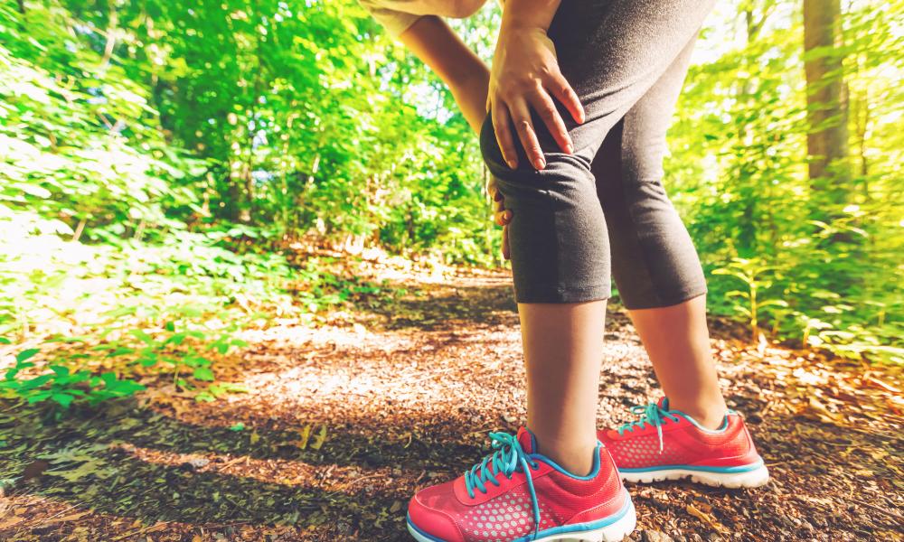 Woman holding her knee in pain