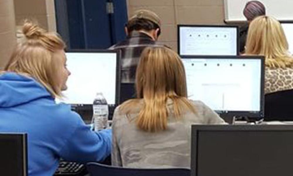 Students working at computers completing their FAFSA 