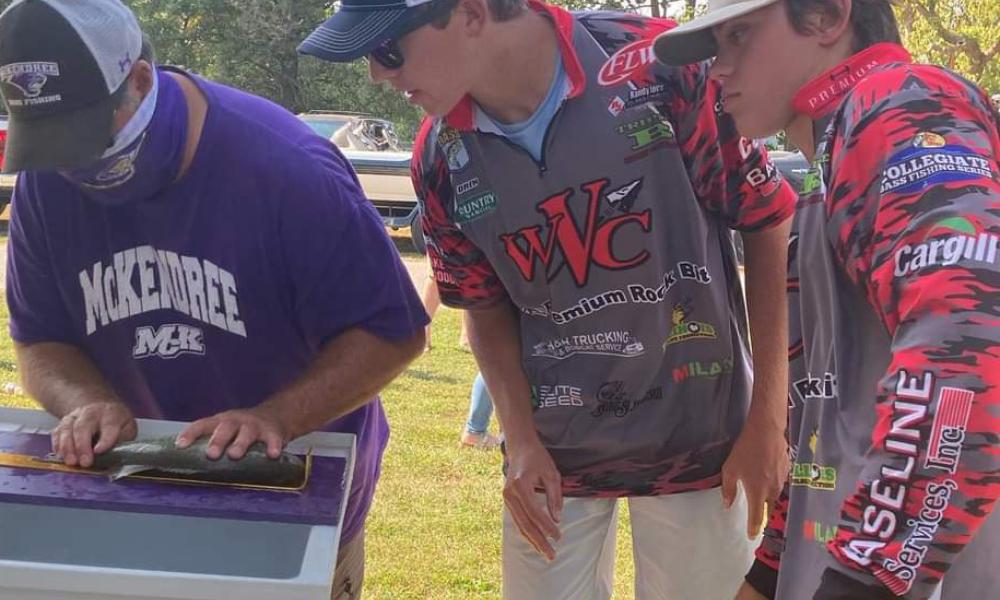 Halbig and Gill watch their fish being weighed