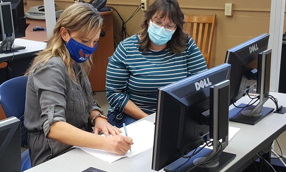 Medical Office Student Working With Instructor