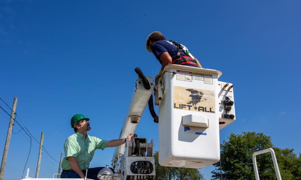 Dennis York instructs a Lincoln Trail College Broadband Telecom student on bucket truck operations