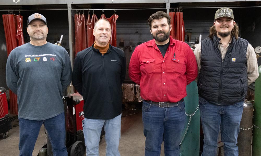 From left to right, welding instructors Dennis York, Kenneth Pierson, Maverick Fisher, and Will Bookhout stand in the McCoy Welding Center at Lincoln Trail College.