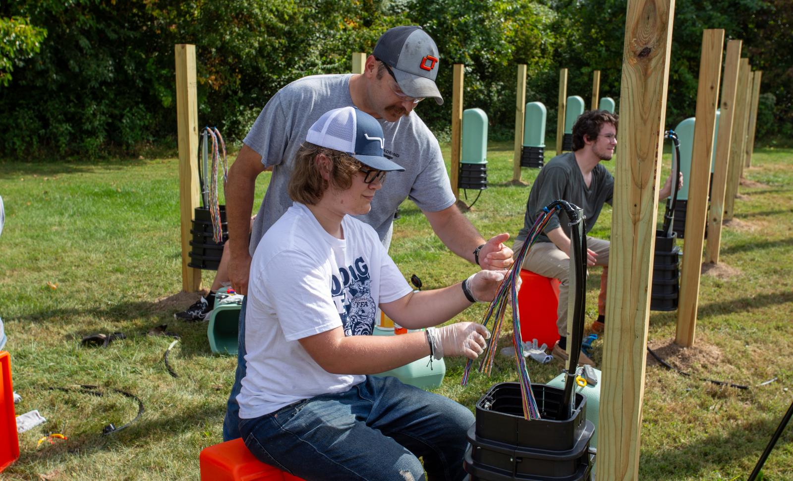 LTC Telecom Instructor Dennis York works with a student splicing cables