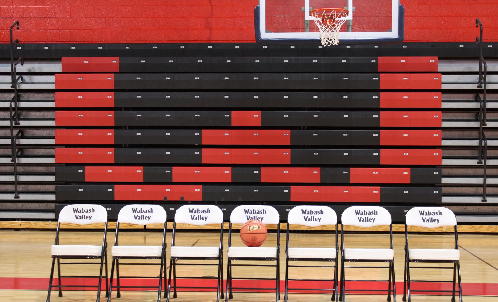 Row of chairs with basketball sitting on the middle chair