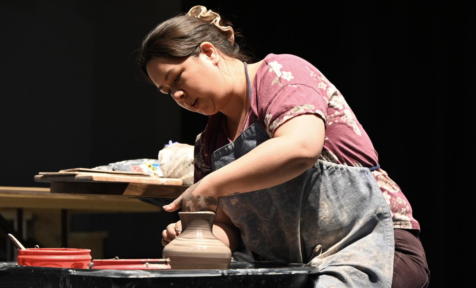 Photo of Instructor Mari Yamato creating a clay pot on the pottery wheel