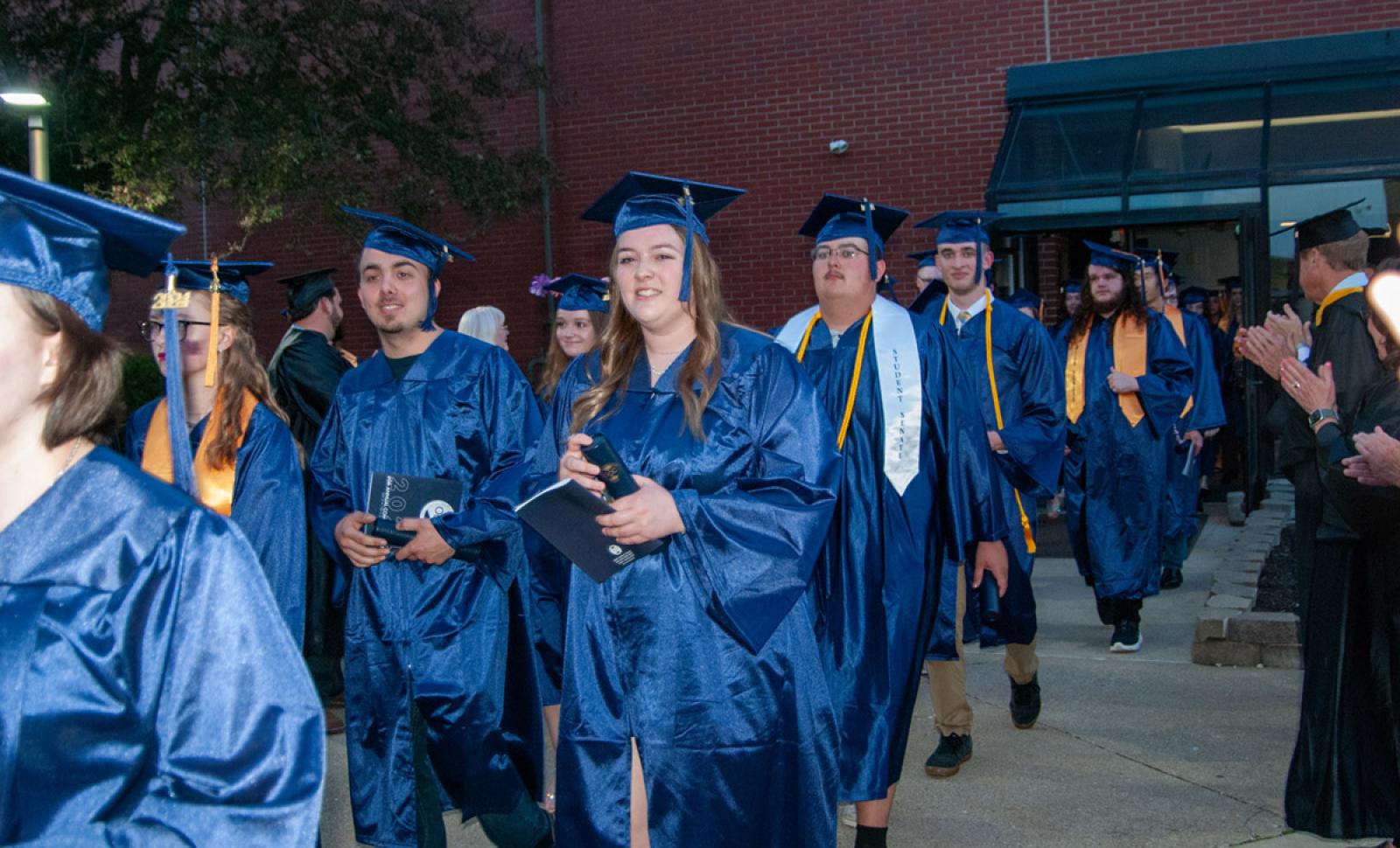 Graduates walking out of the gym