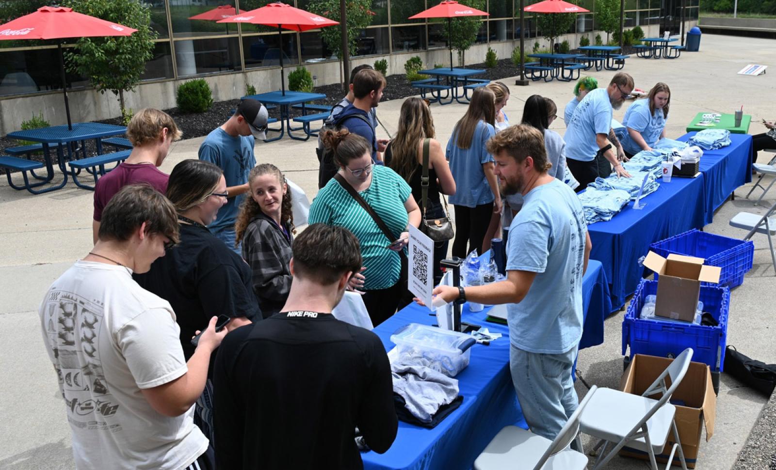 Photo of Students Gathering Around Orientation Table