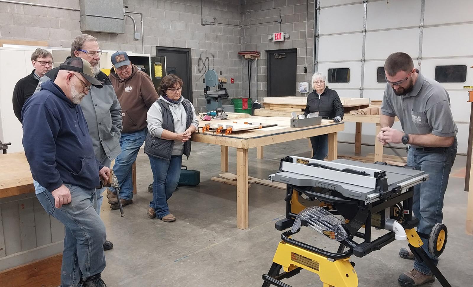 Students watching instructor in woodworking class