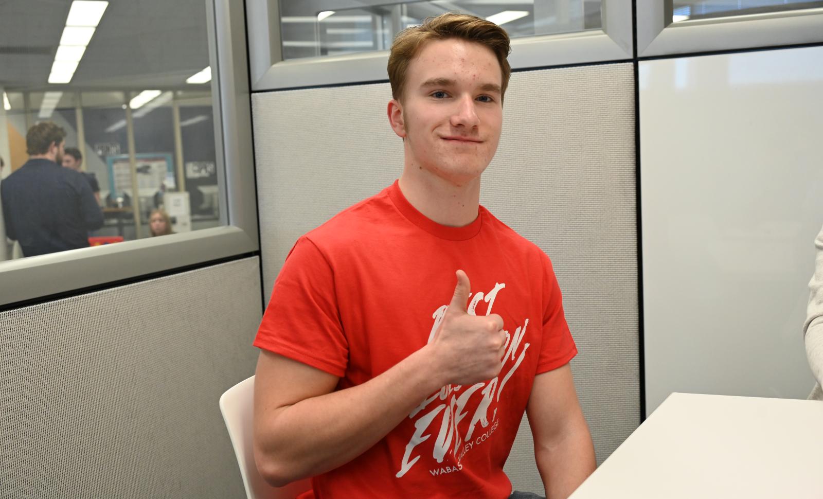 WVC Ambassador Blake McDonald give a thumbs up wearing a red Best Decision Ever t-shirt