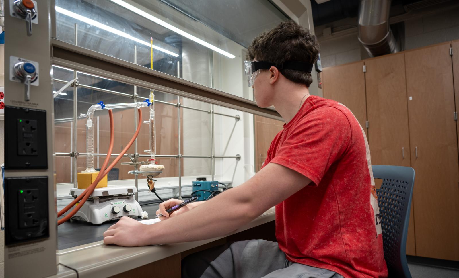 Student works on a chemistry experiment in the newly updated lab.