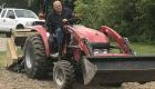 Photo of man on tractor planting pollinator plot