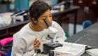 Woman studying microscope