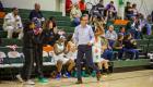 Adam Rotar walks the sideline in front of the Lady Statesmen bench