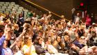 Students raising their hands at orientation