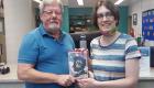 Photo of David Spitz Holding Novel with Kaitlyn Weger