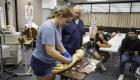 Dr. Jared Gullett oversees a student learning to draw blood