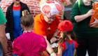 An image of an LTC employee dressed like Toadstool from Super Mario Brothers handing out candy to a trick or treater dressed as Mario.