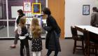 Two children and an adult look at art in LTC's Children's Art Show.