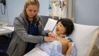 A Lincoln Trail College nursing student uses a stethoscope on a simulation mannequin in a skills lab. The student practices hands-on clinical techniques while surrounded by medical equipment and study materials, preparing for real-world patient care.