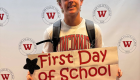 Student holding up "first day of school fall 2025" sign in front of WVC backdrop with seal logo