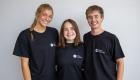 Three Lincoln Trail College Student Ambassadors stand side by side, smiling at the camera. From left to right are Bella Nottger, Emily Miller, and Landry Price, all wearing black Student Ambassador T-shirts against a neutral background.