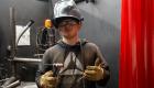 Welding student Jacob Kimbro holds welding tools
