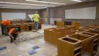Workers begin removing counters during the science lab renovation