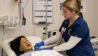 OCC Nursing student examines vital signs on the manikin