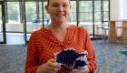 Artist Tanara Ryden displays a fused glass vase 