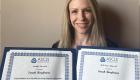 Dr. Sarah Bergbower holds the awards she received.